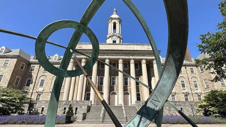 Wide shot of Old Main through Armillary Sphere