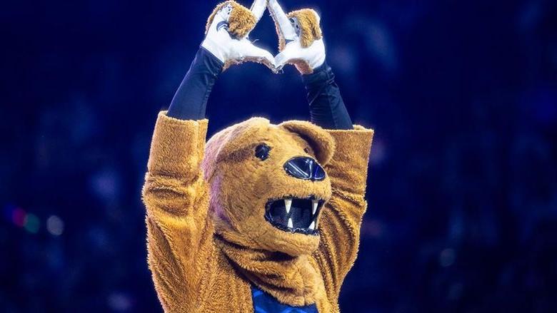 The Penn State Nittany Lion mascot holds his hands above his head forming a diamond during the annual THON fundraiser.